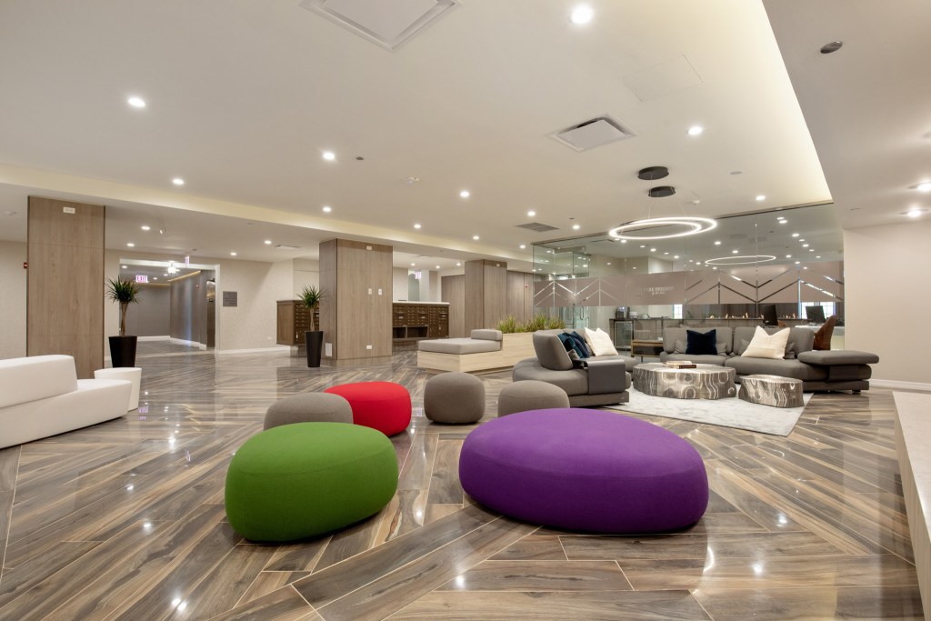 Modern lobby area featuring comfortable seating with colorful poufs and stylish decor.