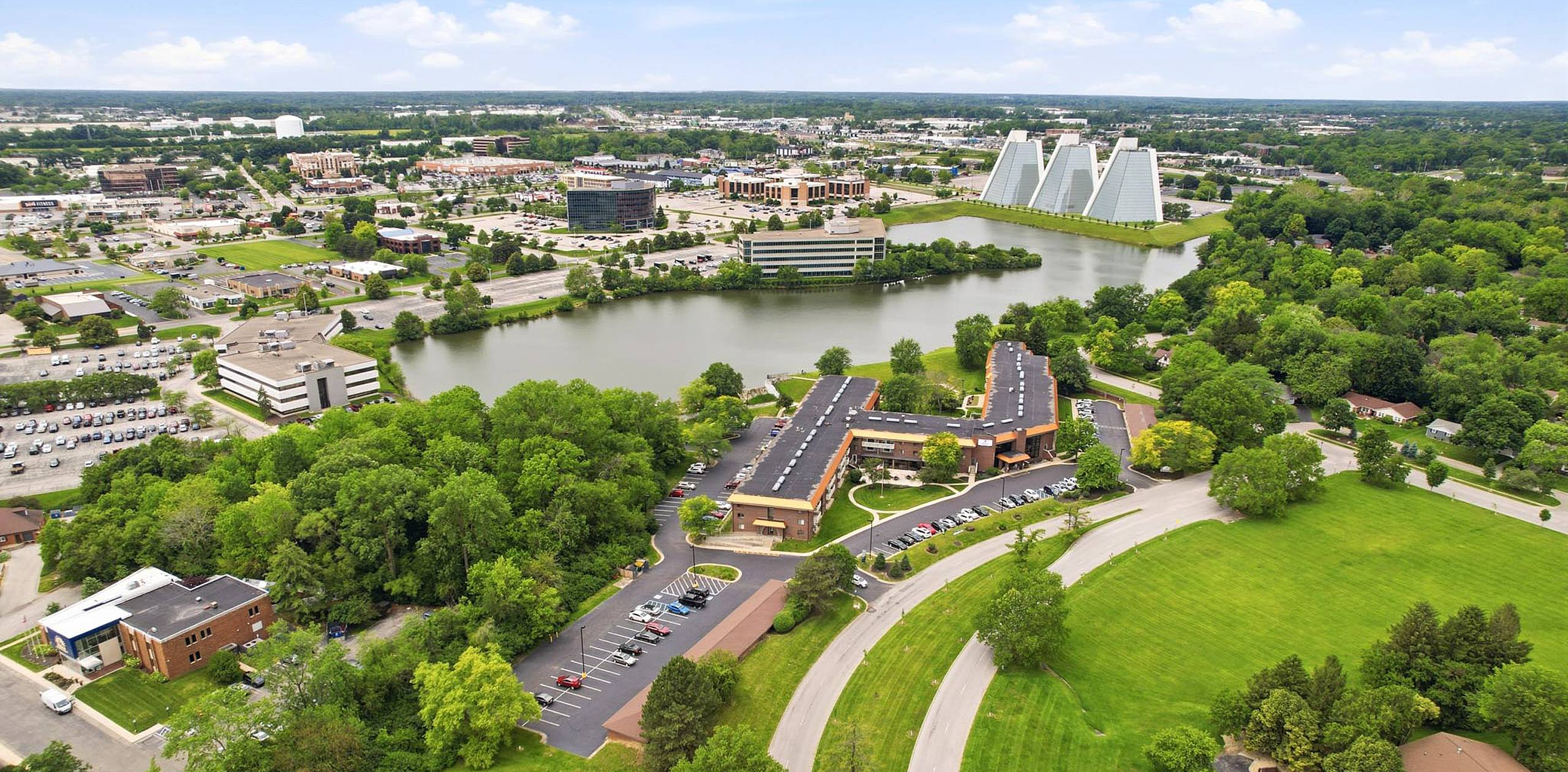 Drone view of King’s Reserve College Park beside the lake with the College Park business district in Indianapolis, Indiana