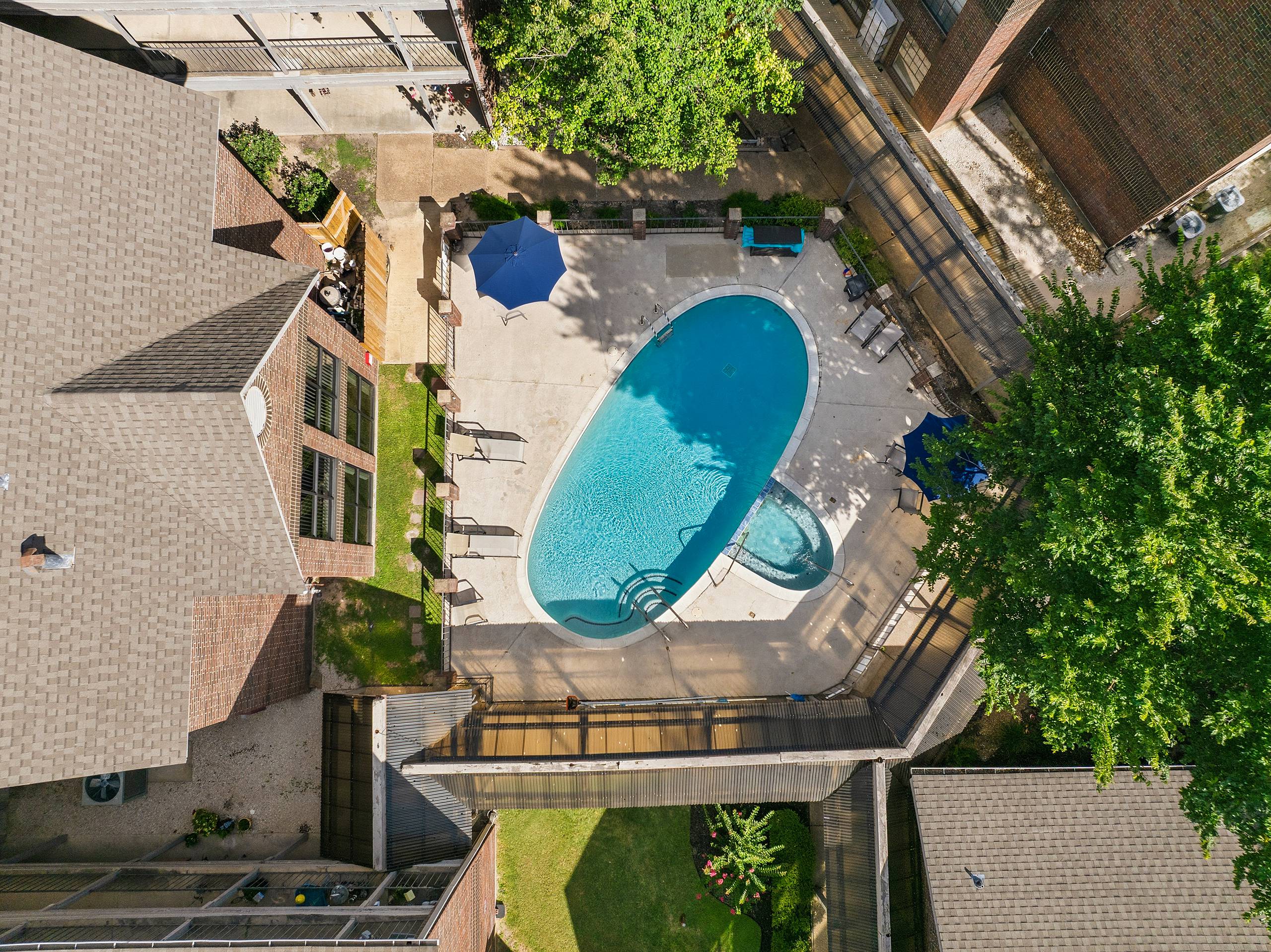Overhead drone view of the courtyard pool and spa at Serenity at Briarcrest in Bryan, Texas
